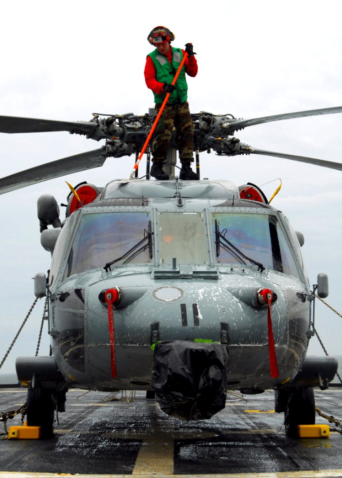 US Navy 100130-N-7058E-108 Sailor cleans a MH-60S helicopter aboard USS Freedom