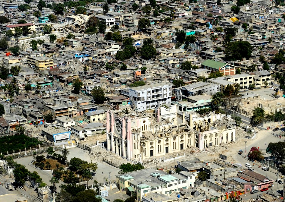 US Navy 100128-N-5345W-148 The Roman Catholic cathedral, in the foreground, and the Haiti capital of Port-au-Prince, are in ruins after the 7.0 magnitude earthquake that struck the region on Jan. 12, 2010