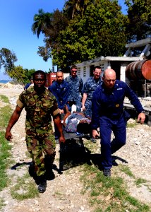 US Navy 100129-N-6676S-007 Sailors carry an injured Haitian woman to the landing zone at the Killick Haitian Coast Guard Base to be airlifted to a nearby treatment facility photo