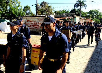 US Navy 100128-N-8655E-086 Sailors assigned to the multi-purpose amphibious assault ship USS Bataan (LHD 5) walk through the town of Grand Goave, Haiti to remove rubble, salvage materials and distribute food to Haitian citizens