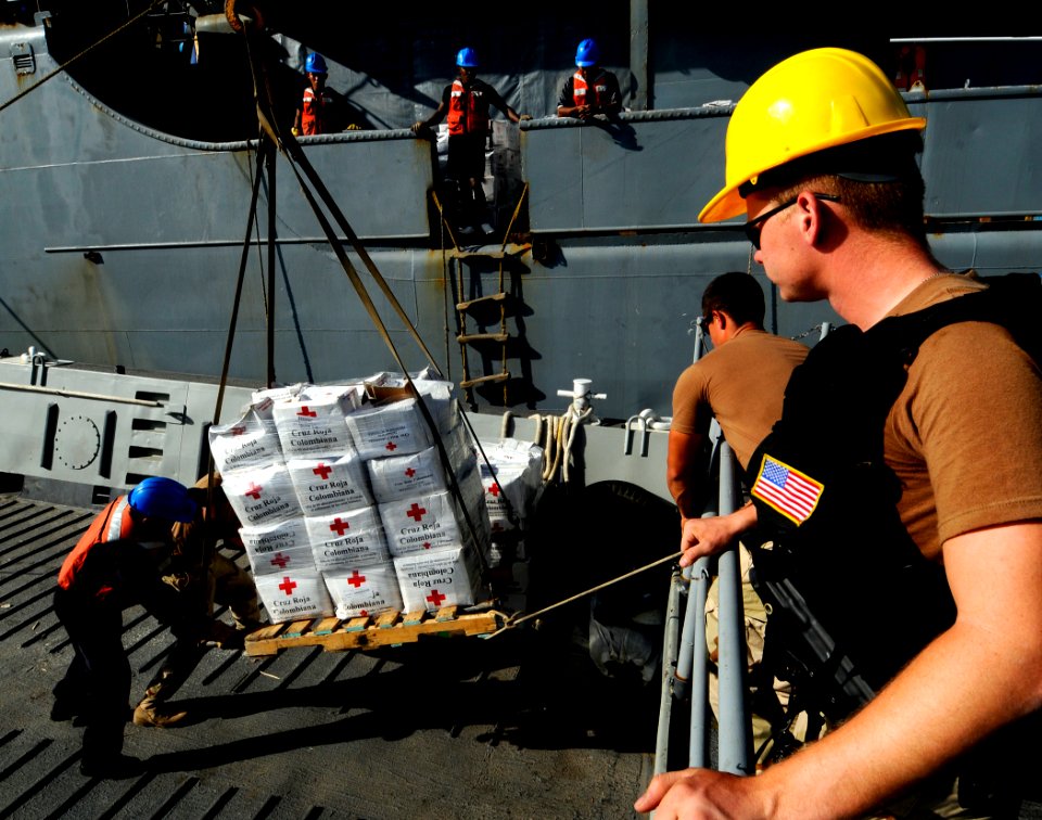 US Navy 100130-N-7948C-216 Logistics Specialist Seaman James Copestake supervises Colombian and U.S. sailors transferring humanitarian supplies from the Colombian navy logistics ship ARC Cartagena De Indias (BM 161) to Landing