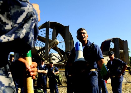 US Navy 100128-N-8655E-040 Lt. Joel Castillo briefs Sailors assigned to the multi-purpose amphibious assault ship USS Bataan (LHD 5) before proceeding into Grande Goave, Haiti to remove rubble