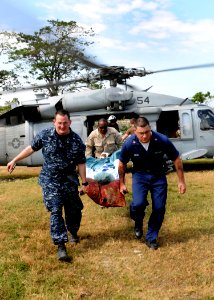 US Navy 100131-N-6676S-003 Sailors ransport a patient from the Military Sealift Command hospital ship USNS Comfort (T-AH 20) to the Killick Haitian Coast Guard Base medical clinic photo