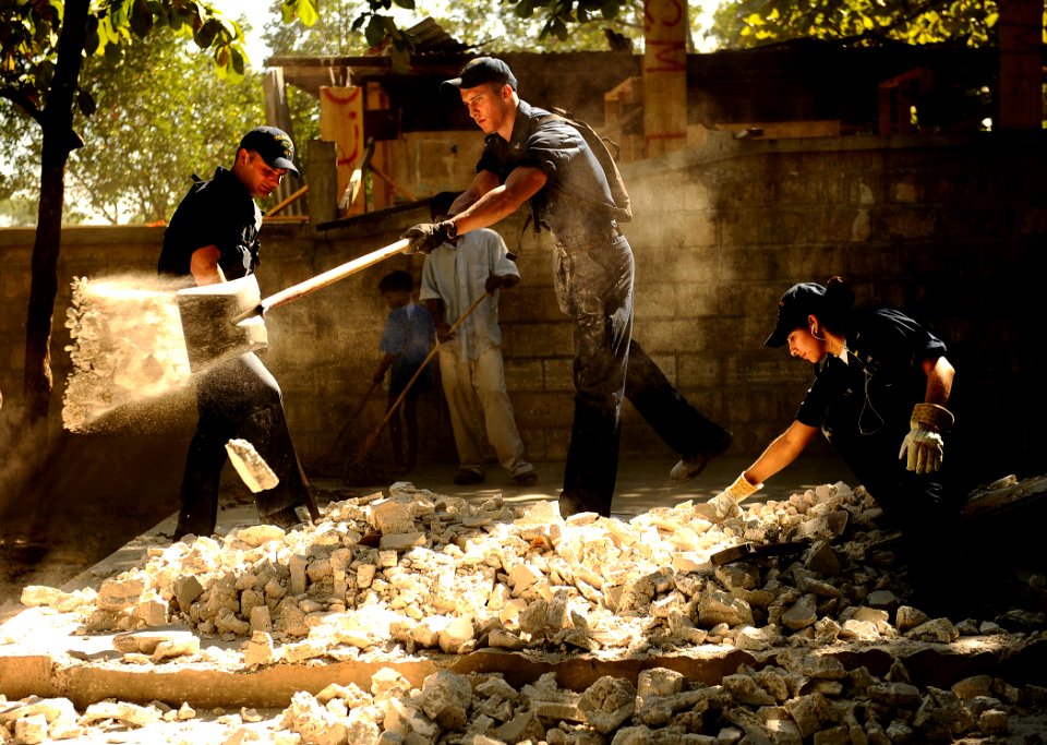US Navy 100129-N-5345W-096 Sailors sift through debris during a clean up an outdoor classroom at the Lifeline Christian Ministries Mission in Grand Goave, Haiti