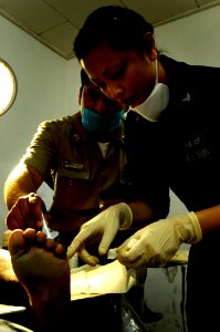 US Navy 100129-N-7948C-037 Hospital Corpsman 1st Class Erly Heras works with a Mexican navy doctor