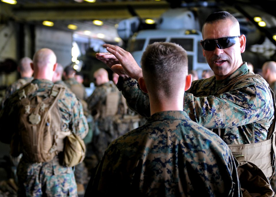 US Navy 100131-N-9950J-220 1st Sgt. Rogelio Haro briefs one of his Marines during a medical evacuation drill in the hangar bay of the forward-deployed amphibious assault ship USS Essex (LHD 2)