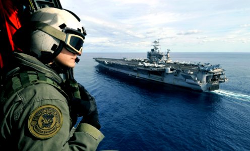 US Navy 100129-N-6003P-031 Naval Air Crewman 3rd Class Mark Bellon conducts a visual patrol out of an SH-60F Sea Hawk helicopter