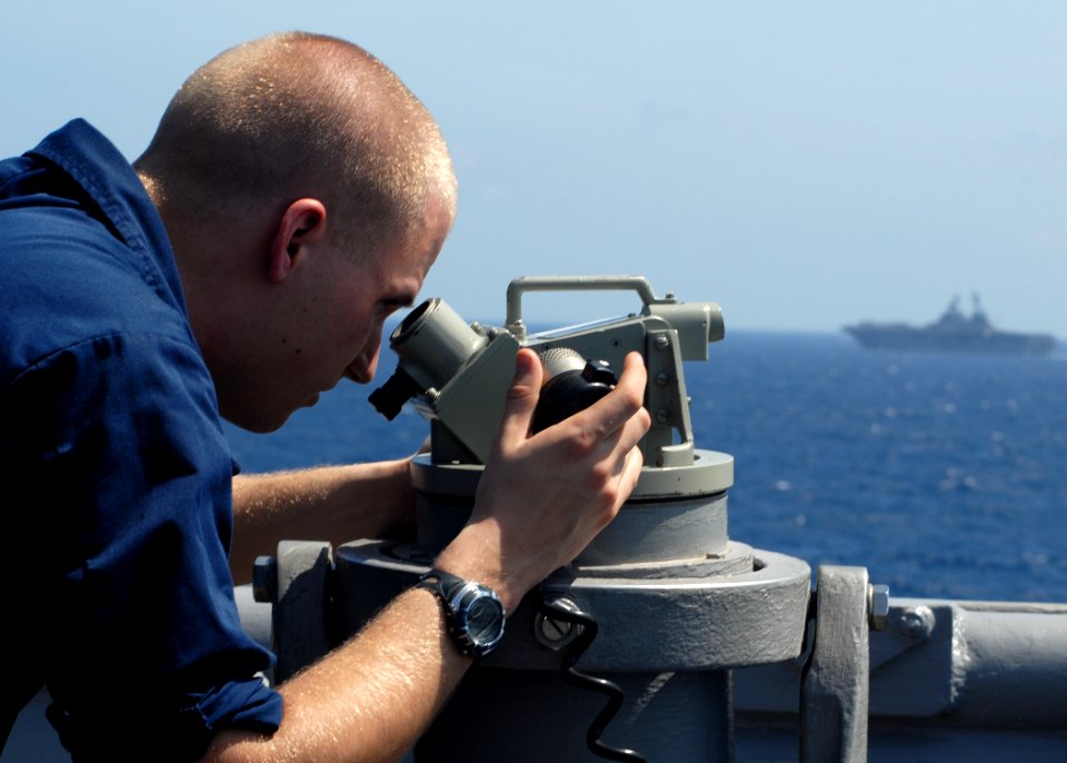 US Navy 100129-N-6692A-041 Sailor checks the bearing of USS Harpers Ferry