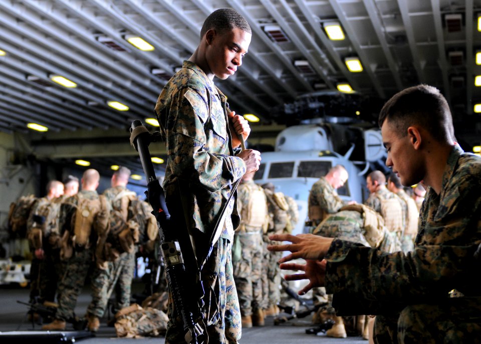 US Navy 100131-N-9950J-010 Cpl. Brandon Brown, left, and Lance Cpl. Joel Rogers prepare for a medical evacuation drill in the hangar bay of the forward-deployed amphibious assault ship USS Essex (LHD 2)