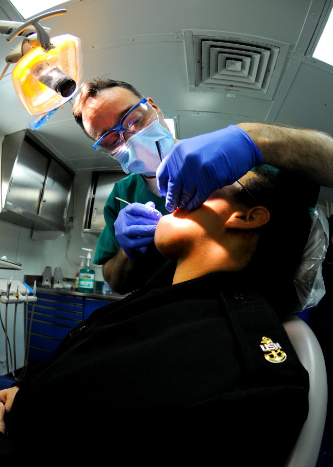 US Navy 100129-N-9950J-048 A dental officer performs exam aboard USS Essex
