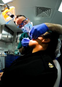 US Navy 100129-N-9950J-048 A dental officer performs exam aboard USS Essex