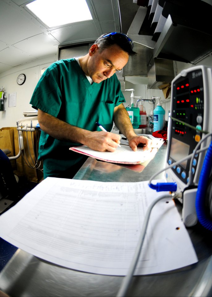 US Navy 100129-N-9950J-091 A dental officer updates records aboard USS Essex