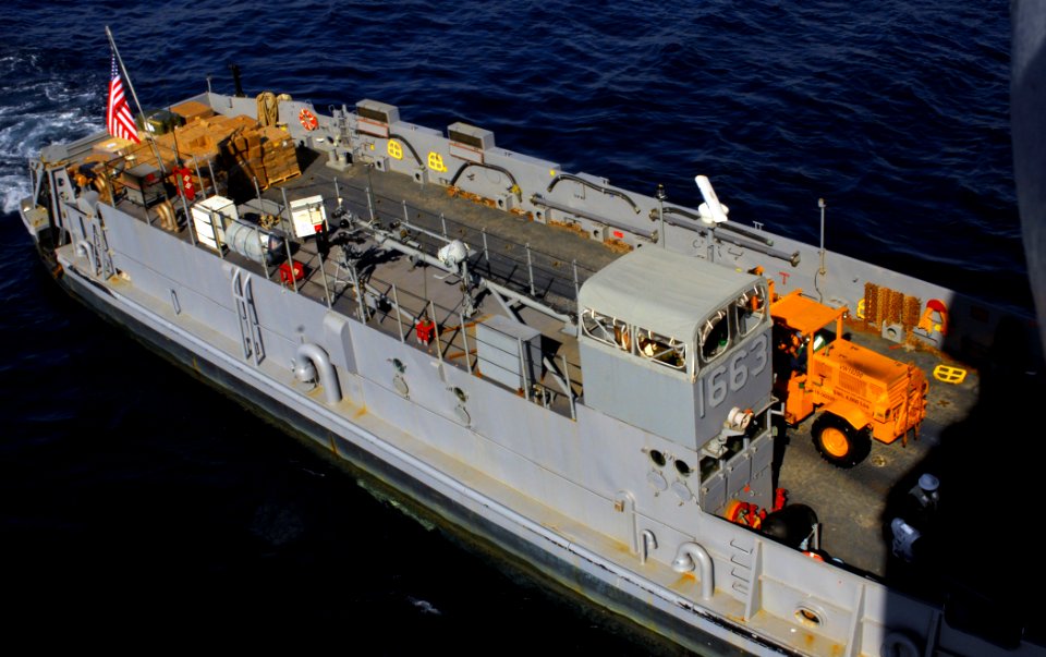 US Navy 100201-N-5214S-002 anding Craft Unit (LCU) 1663, assigned to Assault Craft Unit (ACU) 2, performs a stern gate marriage with the amphibious assault ship USS Bataan (LHD 5) to take on humanitarian relief supplies