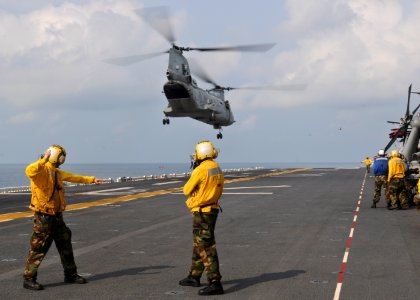 US Navy 100201-N-9950J-360 Aviation Boatswain's Mate (Handling) Airman Daniel Tesauro, left, from New Jersey, and Aviation Boatwain's Mate (Handling) 3rd Class Lois Braxton, from New York, direct the lift off of a CH-46E Sea Kn