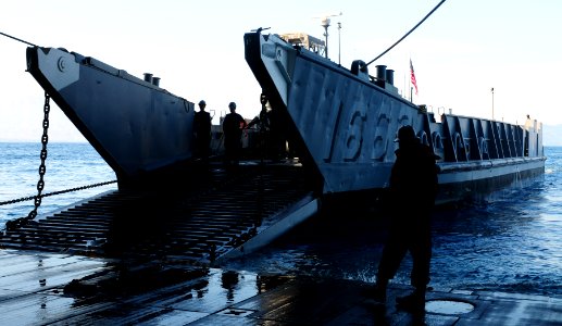 US Navy 100201-N-1831S-052 ilors from Landing Craft Unit (LCU) 1663, assigned to Assault Craft Unit (ACU) 2, load supplies during a stern gate marriage with the amphibious assault ship USS Bataan (LHD 5)