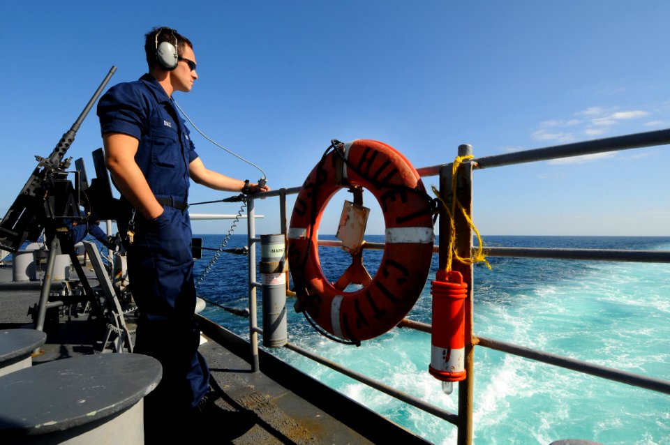 US Navy 100130-N-1688B-100 eaman Walter Diaz-Arias stands the aft lookout watch aboard the guided-missile cruiser USS Hue City (CG 66)