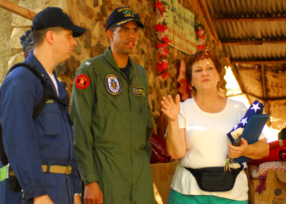 US Navy 100130-N-1092P-305 Capt. Sam Howard, commanding officer of the amphibious assault ship USS Bataan (LHD-5), speaks with Lifeline Christian Mission co-founder Gretchen DeVoe in Grand Goave, Haiti