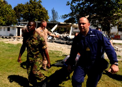US Navy 100129-N-6676S-008 Sailors carry an injured Haitian woman to the landing zone at the Killick Haitian Coast Guard Base to be airlifted to a nearby treatment facility