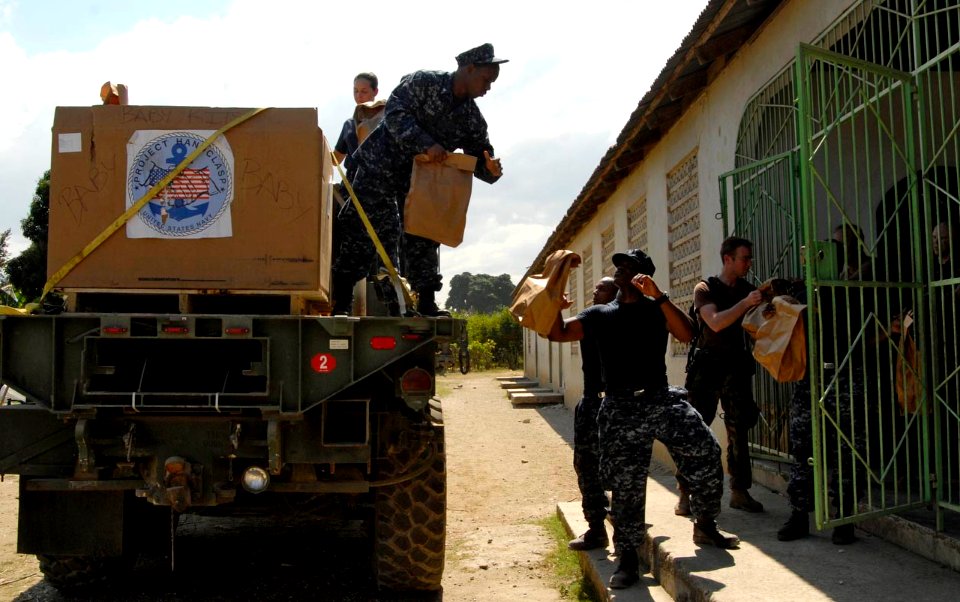 US Navy 100201-N-7653W-144 Sailors assigned to the amphibious dock-landing ship USS Fort McHenry (LSD 43) unload medical and hygiene supplies donated to Project Handclasp for distribution in Haiti