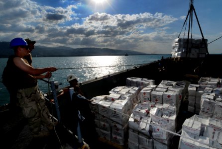 US Navy 100130-N-7948C-271 Engineman Fireman Brandon Livergood helps transfer humanitarian supplies from the Colombian navy logistics ship ARC Cartagena De Indias (BM 161) to Landing Craft Mechanized (LCM) 14