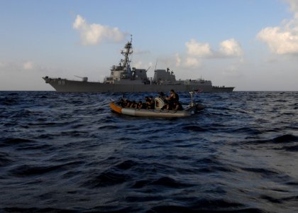 US Navy 100202-N-7088A-028 Members of the visit, board, search and seizure team of the Arleigh Burke-class guided-missile destroyer USS Farragut (DDG 99) leave the ship to investigate a Somali skiff photo