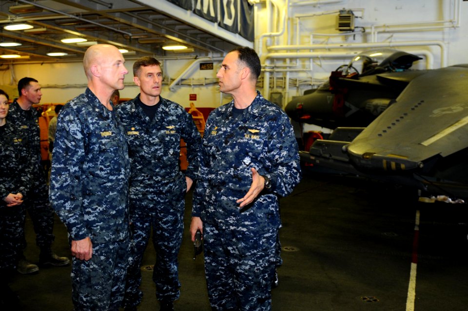 US Navy 100130-N-8936G-049 Rear Adm. David Thomas Jr., Capt. John G. Bruening, Capt. Ronald Reis speak in the Nassau hangar bay