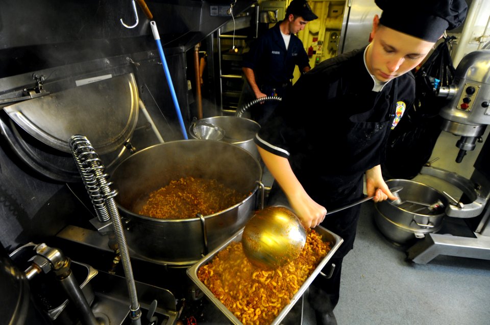 US Navy 100130-N-1688B-117 Culinary Specialist Seaman Apprentice Kiley Margenson prepares lunch for the crew of the guided-missile cruiser USS Hue City (CG 66)