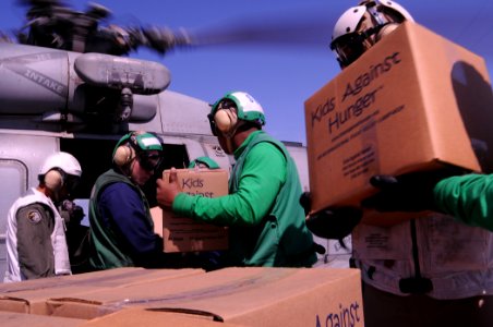 US Navy 100131-N-8878B-242 aboard the Nimitz-class aircraft carrier USS Carl Vinson (CVN 70) load food from the nonprofit organization Kids Against Hunger onto a helicopter from Helicopter Anti-Submarine Squadron (HS) 11