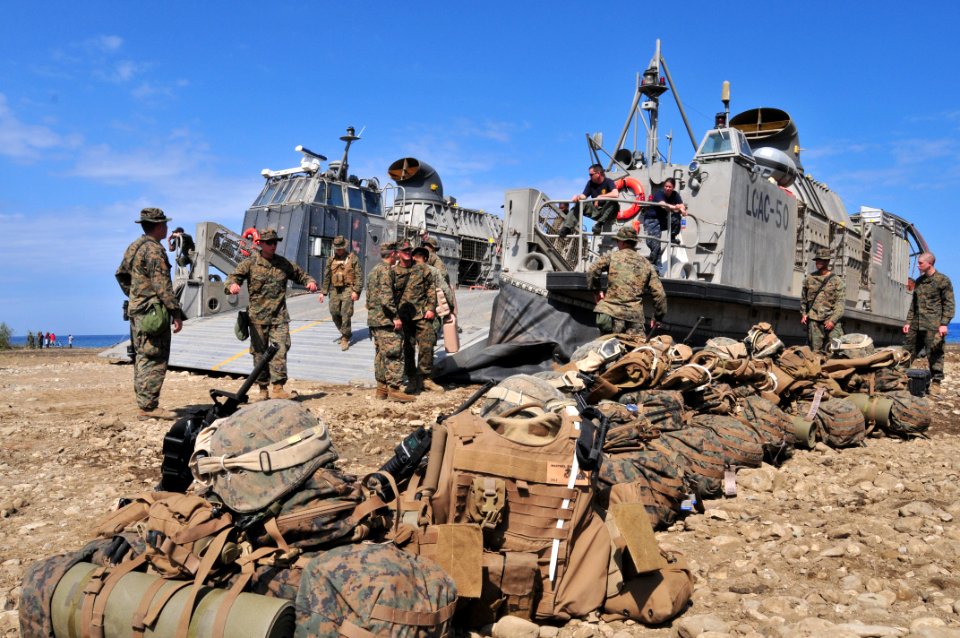 US Navy 100131-N-9740S-288 Marines assigned the 22nd Marine Expeditionary Unit (22nd MEU) await transport to the amphibious assault ship USS Bataan (LHD 5) from a beach in Grand Goave, Haiti