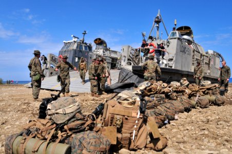 US Navy 100131-N-9740S-288 Marines assigned the 22nd Marine Expeditionary Unit (22nd MEU) await transport to the amphibious assault ship USS Bataan (LHD 5) from a beach in Grand Goave, Haiti photo