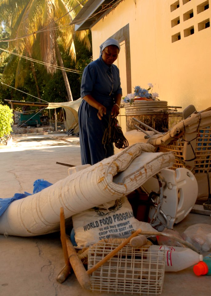 US Navy 100203-N-2000D-168 A nun separates items removed from a damaged section of the Hospital Cardinal de Legar in Leogane, Haiti