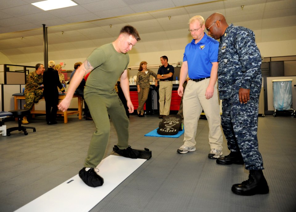 US Navy 100201-N-6326B-093 Marine Lance Cpl. Michael G. Sanders uses a slide board to strengthen his legs