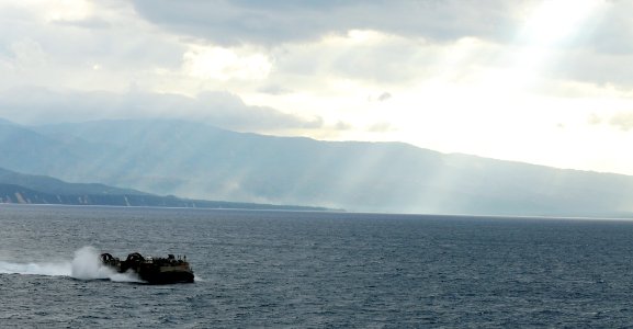 US Navy 100201-N-1831S-089 A landing craft air cushion (LCAC), assigned to Assault Craft Unit (ACU) 4, transits near Baie De Grand Goave, Haiti as it returns to the amphibious assault ship USS Bataan (LHD 5)