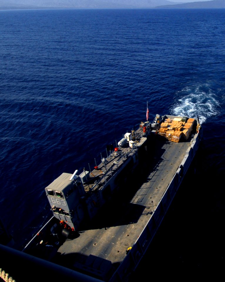 US Navy 100201-N-5214S-013 anding Craft Unit (LCU) 1663, assigned to Assault Craft Unit (ACU) 2, performs a stern gate marriage with the amphibious assault ship USS Bataan (LHD 5) to take on humanitarian relief supplies