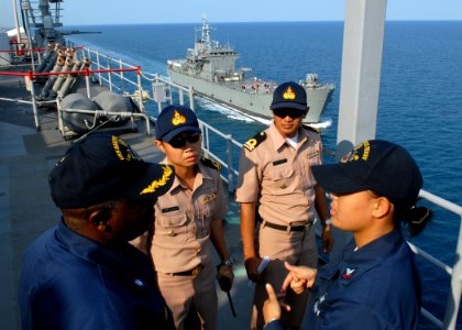 US Navy 100203-N-6692A-159 Electronics Technician 2nd Class Bounthome Khattiya translates for Royal Thai Navy officers