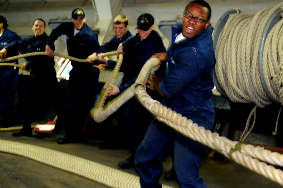 US Navy 100201-N-7478G-186 Seaman Darrell Moore and fellow line handlers heave a mooring line in the foc'sle aboard the U.S. 7th Fleet command ship USS Blue Ridge (LCC 19)