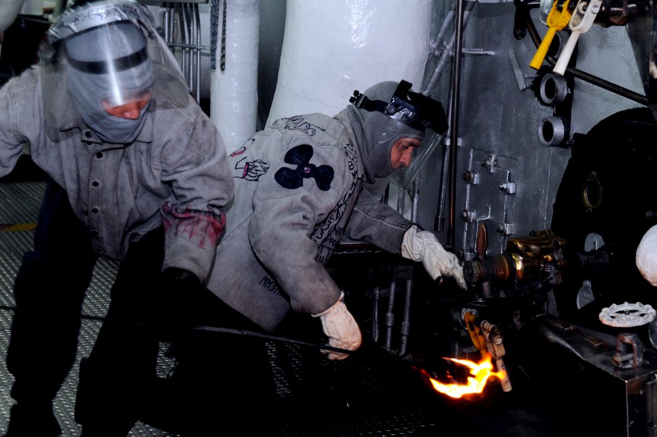 US Navy 100203-N-7280V-201 Machinist 's Mate 2nd Class Janeleazar Rodriguez and Machinist 's Mate 2nd Class Ernest Taylor ight the 1B boiler as Blue Ridge transits the Tsugaru Straits
