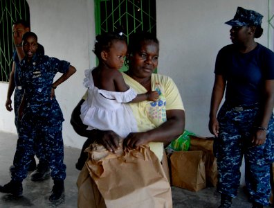 US Navy 100201-N-7653W-449 rs assigned to the amphibious dock-landing ship USS Fort McHenry (LSD 43) distribute medical and hygiene supplies to Haitian citizens at a humanitarian aid distribution center
