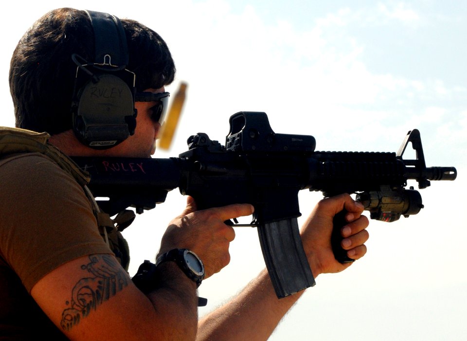 US Navy 100201-N-1291E-042 Explosive Ordnance Disposal Technician 2nd Class Christopher Ruley, assigned to Explosive Ordnance Disposal Mobile Unit (EODMU) 11, fires his M-4 rifle at a military shooting range in Bahrain
