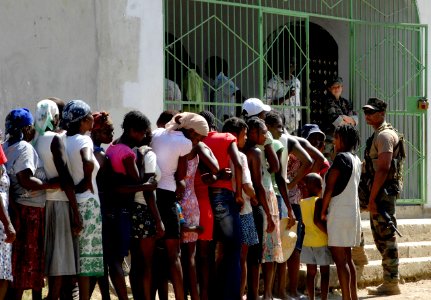 US Navy 100201-N-7653W-206 Haitian citizens queue in front of a humanitarian aid distribution center to pick up medical and hygiene supplies distributed by Sailors assigned to the amphibious dock-landing ship USS Fort McHenry (