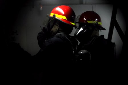 US Navy 100203-N-7280V-162 ailors aboard the U.S. 7th Fleet command ship USS Blue Ridge (LCC 19), respond to a simulated fire during a general quarters drill
