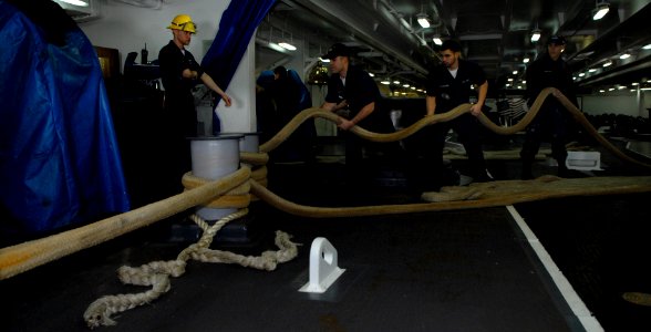 US Navy 100202-N-2475A-024 Deck department Sailors heave mooring lines in the forecastle aboard the Nimitz-class aircraft carrier USS John C. Stennis (CVN 74) during their departure from San Diego