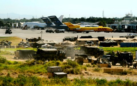 US Navy 100202-N-5345W-075 Multi-national military and civilian cargo aircraft are on the flight line at Aerodome de Jacmel in Port-au-Prince, Haiti, as U.S. service members work from their base camps near the airport tarmac