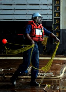 US Navy 100201-N-5538K-036 Sailor prepares to throw line to a landing craft utility