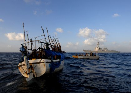 US Navy 100202-N-7088A-061 Members of the visit, board, search and seizure team of the Arleigh Burke-class guided-missile destroyer USS Farragut (DDG 99) investigate a Somali skiff photo