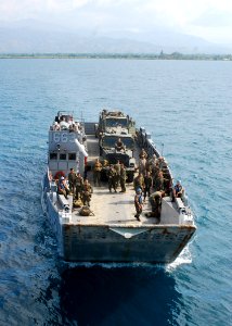 US Navy 100203-N-0924R-006 Landing Craft Unit (LCU) 1663, assigned to Assault Craft Unit (ACU) 2, loaded with embarked Marines from the 22nd Marine Expeditionary Unit (22nd MEU), prepares to enter the well deck of the amphibiou photo