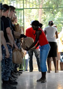 US Navy 100202-N-4971L-125 A Haitian woman receives reliefs supplies
