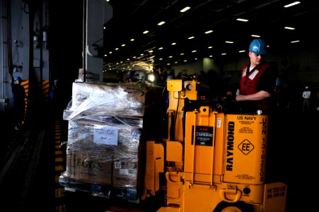 US Navy 100204-N-6604E-018 Aviation Ordnanceman 3rd Class Justin Williams operates a forklift during an underway replenishment aboard the aircraft carrier USS Dwight D. Eisenhower (CVN 69)