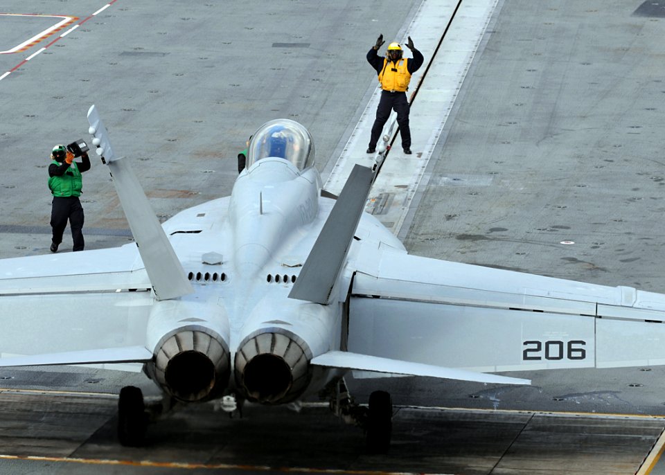 US Navy 100203-N-3885H-005 Flight deck personnel direct an F-A-18F Super Hornet from Strike Fighter Squadron (VFA) 213 aboard the aircraft carrier USS George H.W. Bush (CVN 77)