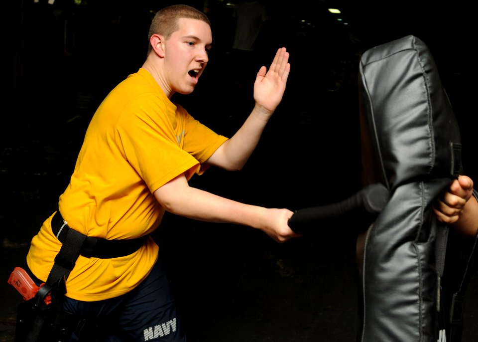 US Navy 100203-N-5538K-162 Fire Controlman 3rd Class Robert L. Keith, left, defends himself from Seaman Jakravitz J. Tunstall with a padded baton during naval security force sentry training aboard the forward-deployed amphibio
